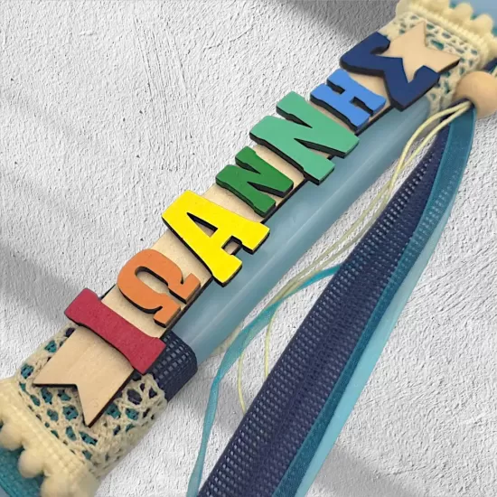 Handmade light blue Easter candle with personalized wooden name decoration and elegant embellishments