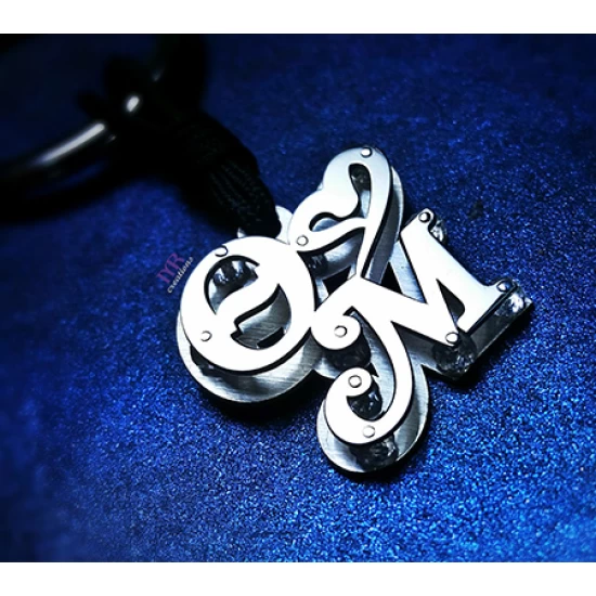 Silver key ring with two calligraphic monograms of your choice.