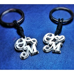 Silver key ring with two calligraphic monograms of your choice.