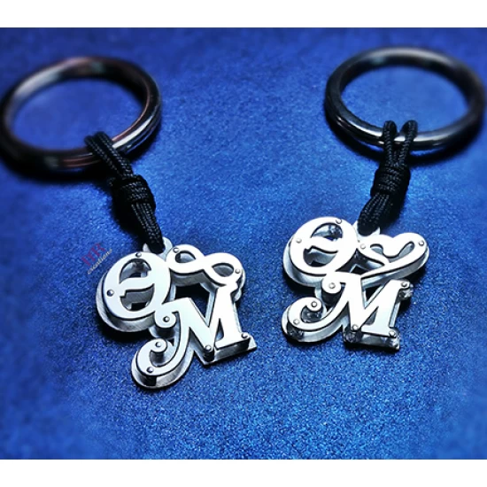 Silver key ring with two calligraphic monograms of your choice.