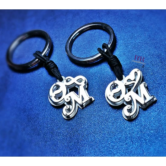 Silver key ring with two calligraphic monograms of your choice.