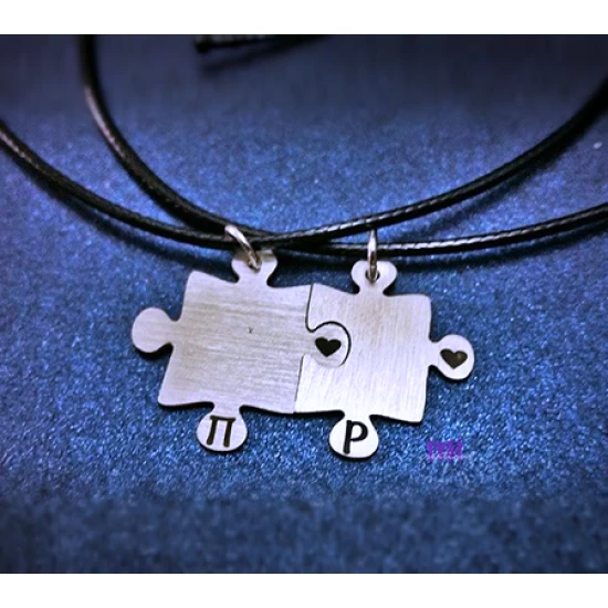 Handmade silver jewelry for couples with 2 puzzle pieces with a heart and initials