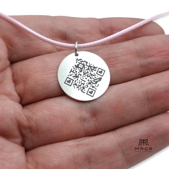 Round silver pendant with hidden QR code message