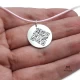 Round silver pendant with hidden QR code message